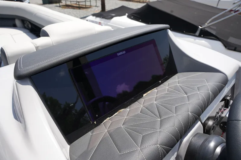 Slide: The Image of The image shows the dashboard of a Harris 250GM boat with a large screen. - 25