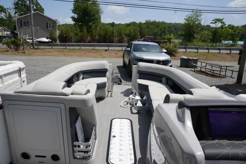 Slide: The Image of The image shows the interior of a 2027 Harris 250GM pontoon boat with gray seating. - 16