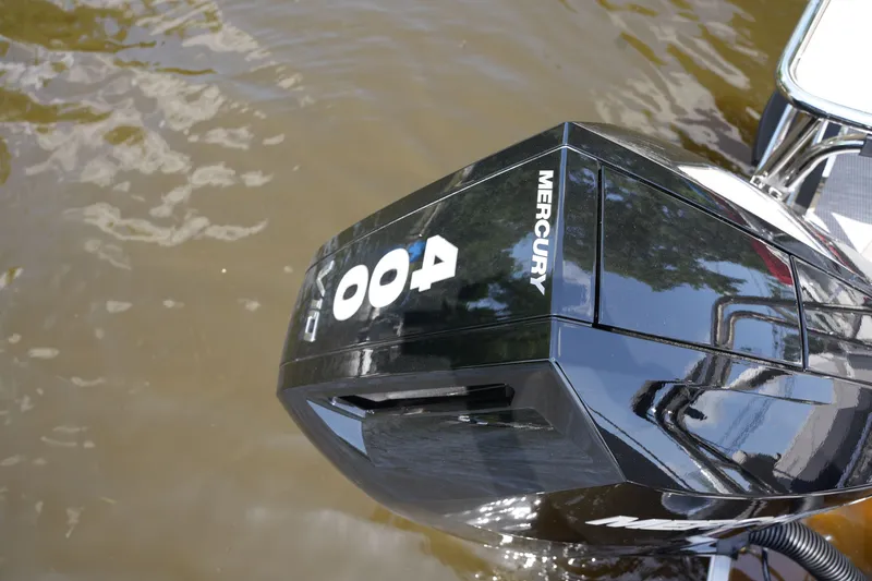 Slide: The Image of A Mercury outboard motor on a boat in the water. - 38