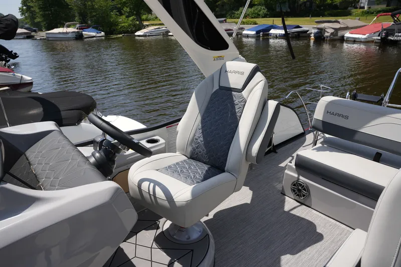 Slide: The Image of The image shows the cockpit of a 2027 Harris 250GM boat with sleek seating. - 22
