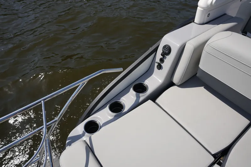 Slide: The Image of Harris 250GM from 2027 with sleek seating and cup holders by the water. - 33