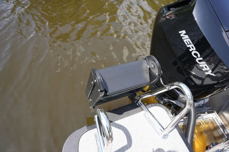 Slide: The Image of A Mercury outboard motor on a boat in the water. - 37