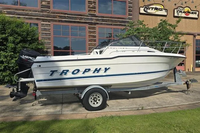 Slide: The Image of Bayliner 2002 Trophy Walkaround boat, 1996 model, on trailer outside a building. - 3