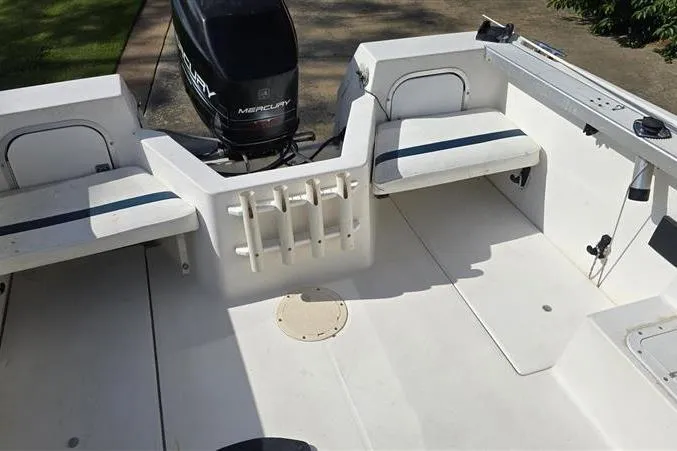 Slide: The Image of 1996 Bayliner Trophy Walkaround boat interior with seating and Mercury outboard motor. - 8