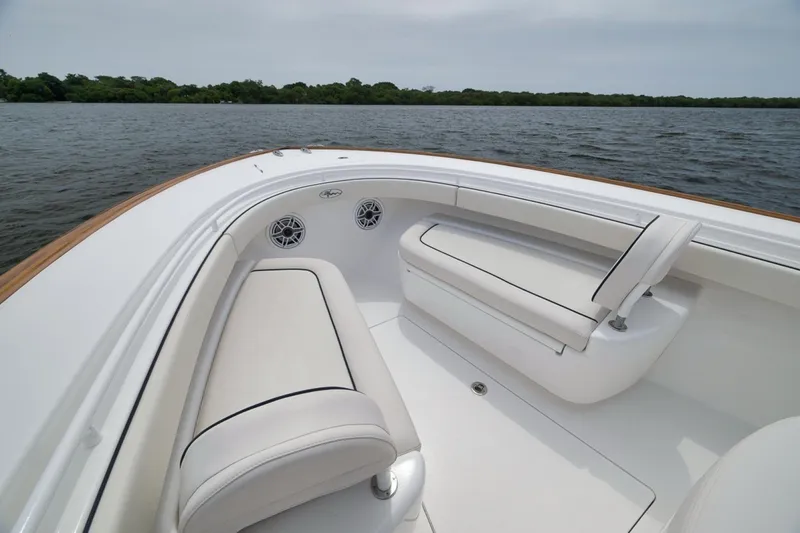 Slide: The Image of 2023 Valhalla Boatworks V-33 interior with white seating on calm water. - 21
