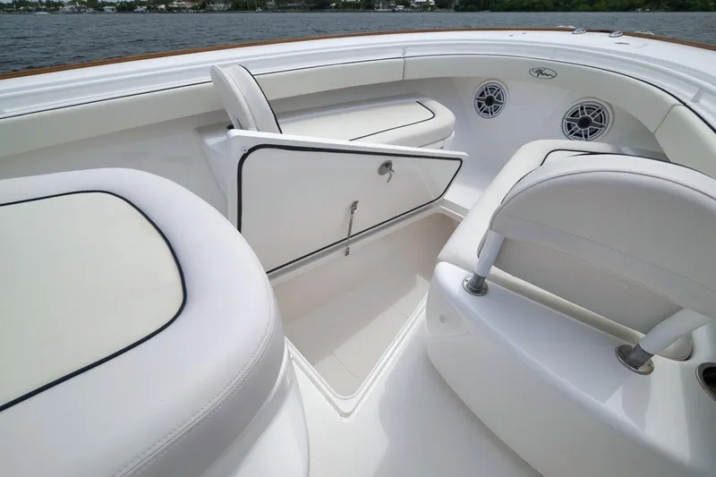 Slide: The Image of 2023 Valhalla Boatworks V-33 interior with white seating and storage compartment. - 23