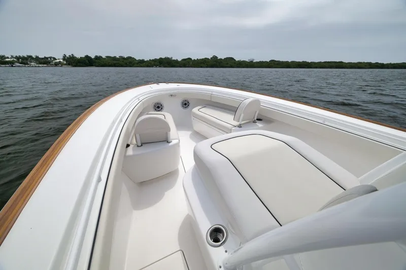 Slide: The Image of 2023 Valhalla Boatworks V-33, sleek white interior, cruising on calm waters. - 28