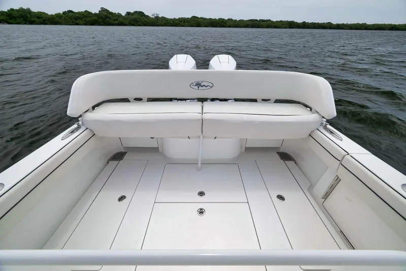 Slide: The Image of 2023 Valhalla Boatworks V-33, spacious deck view, white seating, dual engines, calm waters. - 38