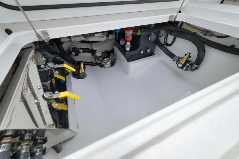 Slide: The Image of Engine compartment of 2023 Valhalla Boatworks V-33, showcasing mechanical components and hoses. - 42