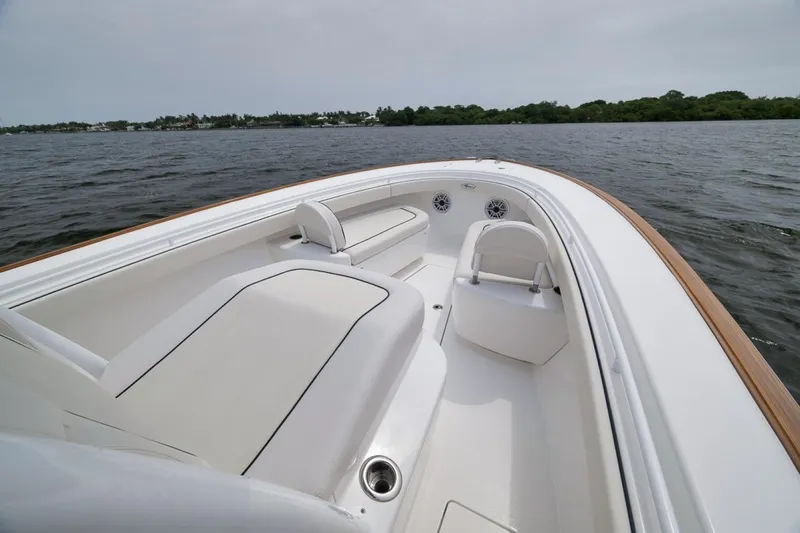 Slide: The Image of 2023 Valhalla Boatworks V-33, sleek white interior, cruising on calm waters. - 27