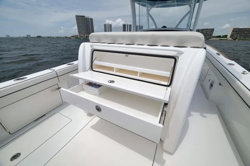 Slide: The Image of 2023 Valhalla Boatworks V-33 with open storage compartments on deck, ocean view background. - 44