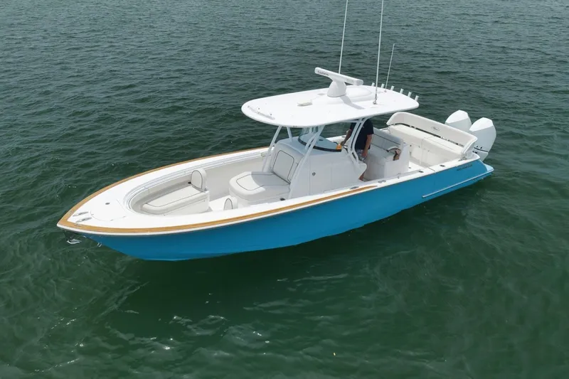 Slide: The Image of 2023 Valhalla Boatworks V-33 in blue, cruising on calm waters. - 6