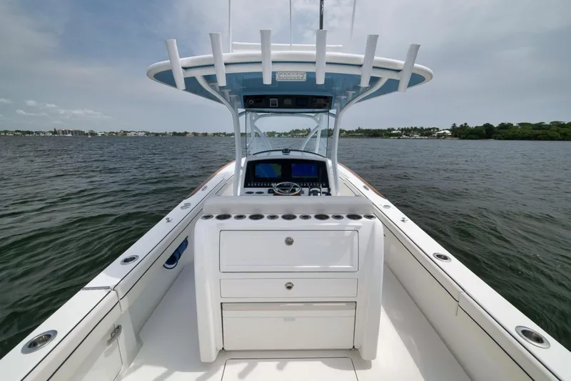 Slide: The Image of 2023 Valhalla Boatworks V-33 center console on open water, showcasing helm and storage. - 43