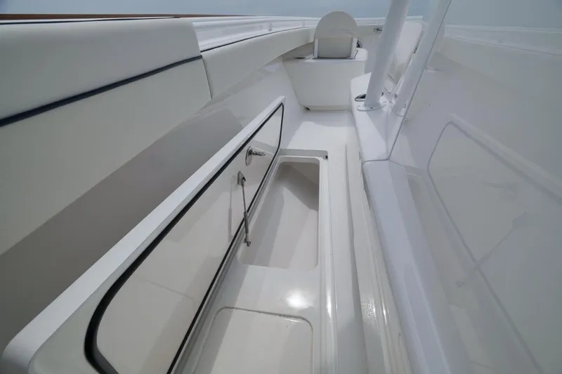 Slide: The Image of 2023 Valhalla Boatworks V-33 interior with sleek white storage compartments. - 30