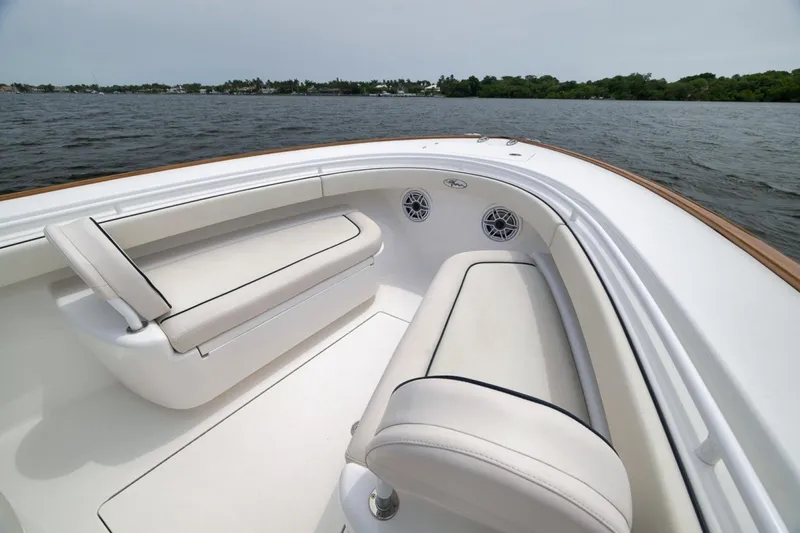 Slide: The Image of 2023 Valhalla Boatworks V-33 interior with white seating, on calm water. - 20