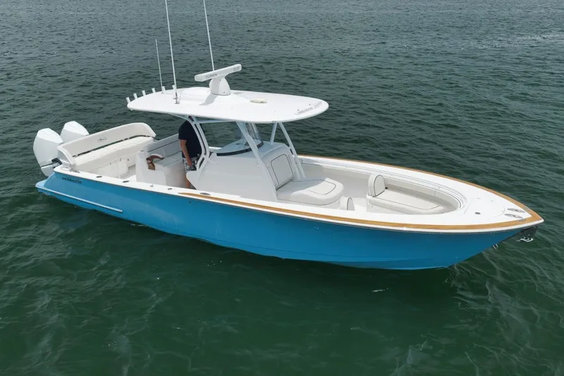 Slide: The Image of 2023 Valhalla Boatworks V-33 in blue, cruising on open water. - 2