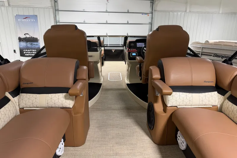 Slide: The Image of 2018 Godfrey Sanpan 2500 ULC pontoon boat interior with luxurious tan seating and modern dashboard. - 18