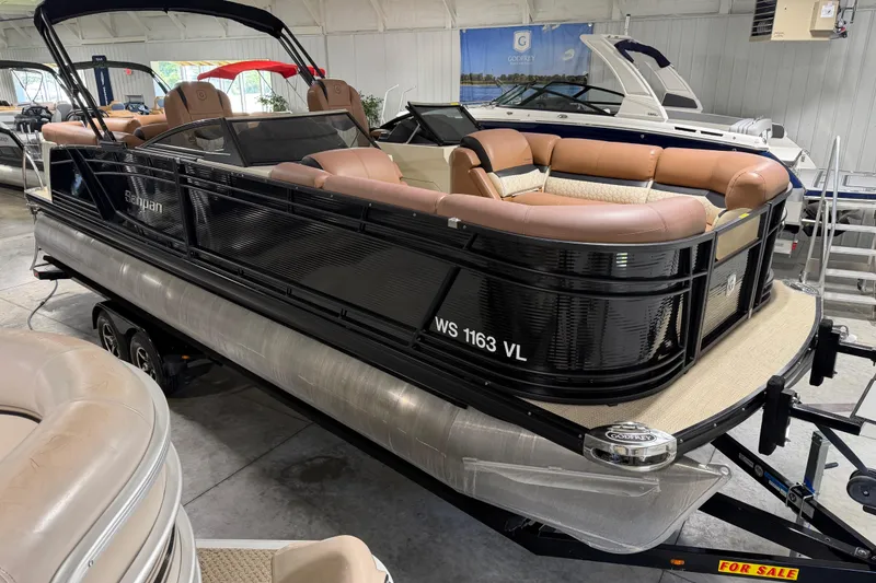 Slide: The Image of 2018 Godfrey Sanpan 2500 ULC pontoon boat with tan seating, displayed indoors for sale. - 5