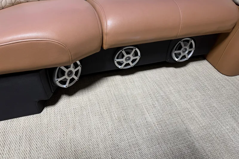 Slide: The Image of 2018 Godfrey Sanpan 2500 ULC boat seating with integrated speakers on carpeted floor. - 8