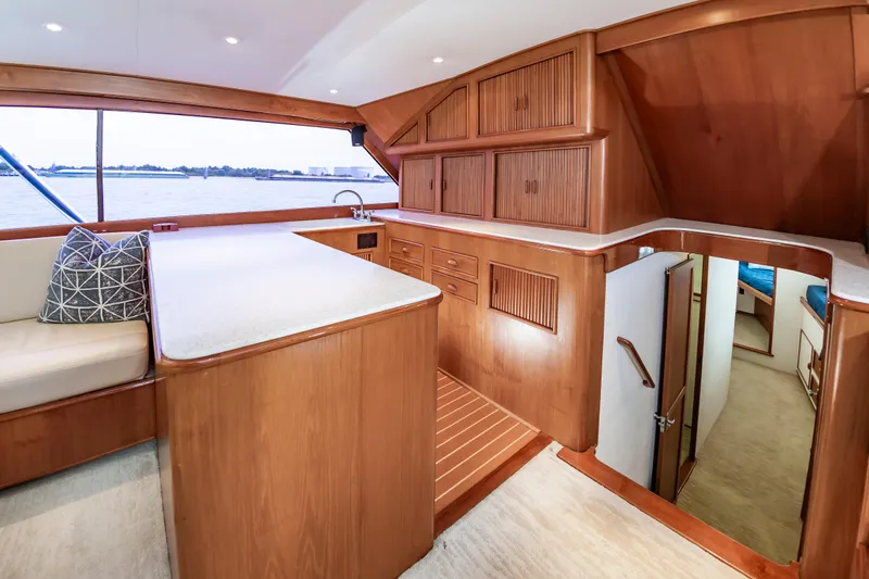 Slide: The Image of Interior of 1993 Custom Carolina Scarborough 56 Convertible yacht with wooden cabinetry and seating. - 19