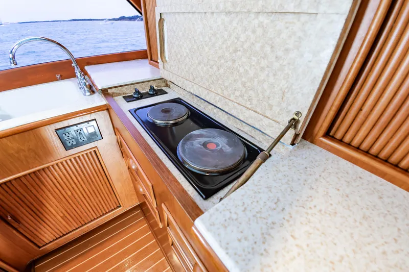 Slide: The Image of Kitchen area of 1993 Custom Carolina Scarborough 56 Convertible yacht with stove and sink. - 22