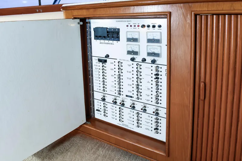 Slide: The Image of Electrical panel inside 1993 Custom Carolina Scarborough 56 Convertible yacht, showcasing controls and meters. - 23