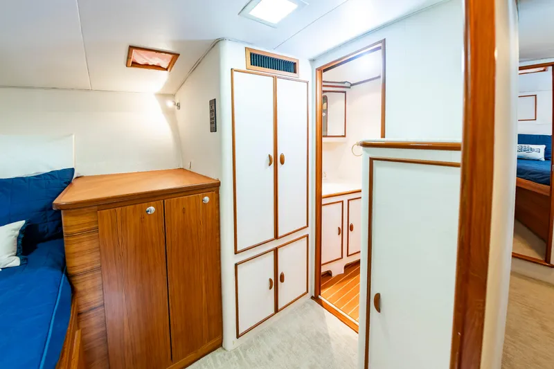 Slide: The Image of Interior of 1993 Custom Carolina Scarborough 56 Convertible yacht with wood cabinetry and cozy seating. - 26