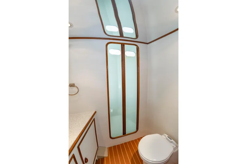 Slide: The Image of Bathroom interior of 1993 Custom Carolina Scarborough 56 Convertible yacht, featuring modern fixtures. - 31