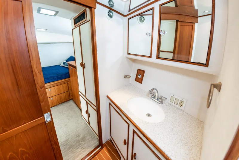 Slide: The Image of Bathroom interior of 1993 Custom Carolina Scarborough 56 Convertible yacht, featuring wood cabinetry and sink. - 32