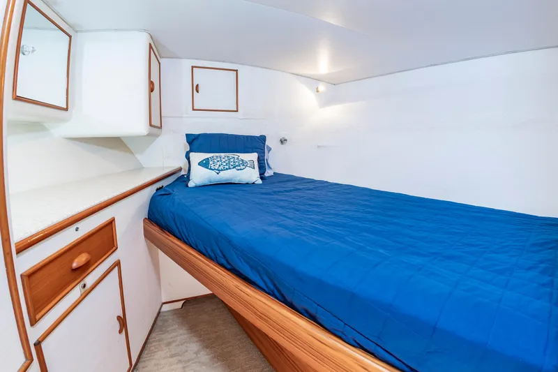 Slide: The Image of Cozy cabin interior of 1993 Custom Carolina Scarborough 56 Convertible with blue bedding and wooden accents. - 38