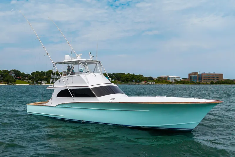 Slide: The Image of Custom Carolina Scarborough 56 Convertible yacht, 1993 model, cruising on a serene waterway. - 41