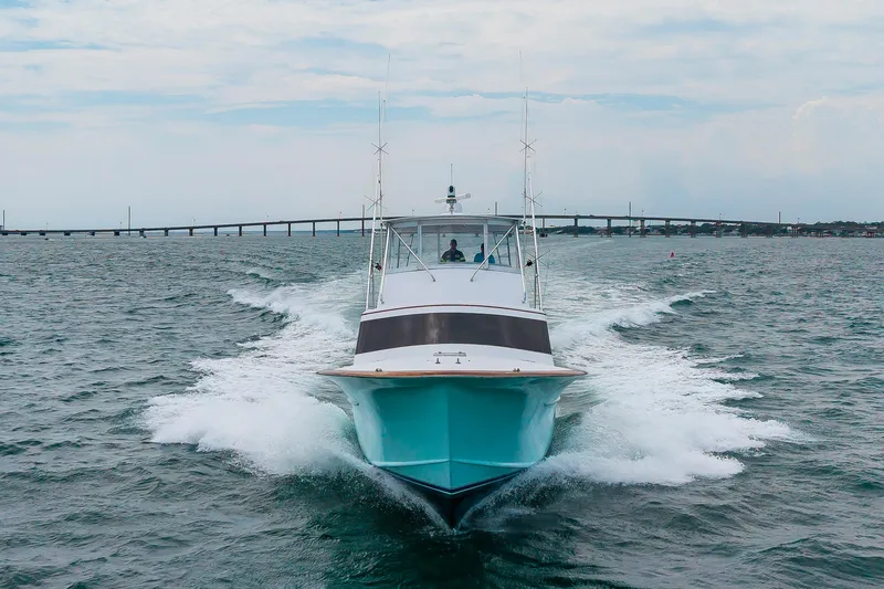 Slide: The Image of Custom Carolina Scarborough 56 Convertible yacht cruising on open water, 1993 model. - 42