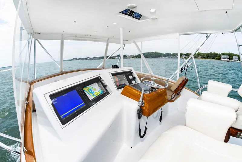 Slide: The Image of Helm of 1993 Custom Carolina Scarborough 56 Convertible yacht with navigation screens and steering wheel. - 5