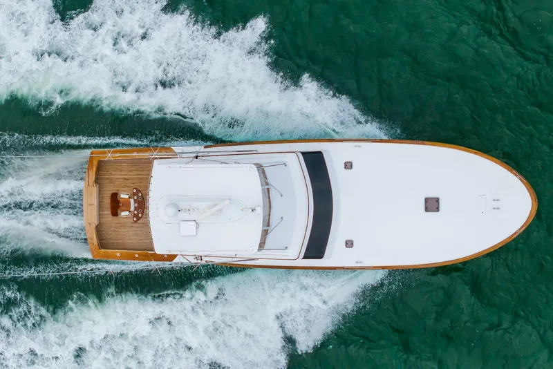 Slide: The Image of Aerial view of 1993 Custom Carolina Scarborough 56 Convertible yacht cruising on turquoise water. - 50