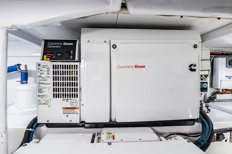 Slide: The Image of Cummins Onan generator in 1993 Custom Carolina Scarborough 56 Convertible engine room. - 64