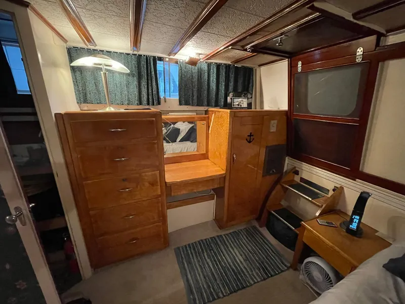 Slide: The Image of 1951 Chris-Craft Catalina cabin interior with wooden furniture and cozy decor. - 14