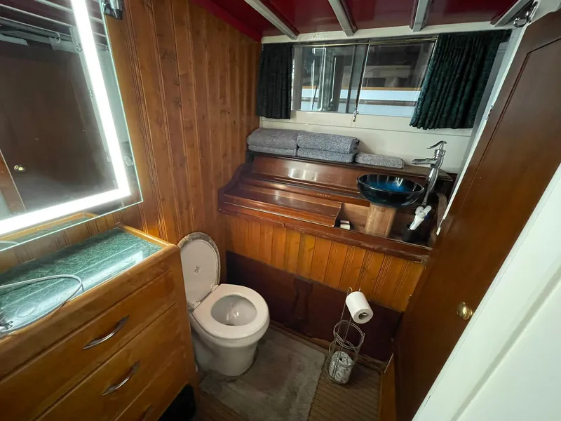 Slide: The Image of 1951 Chris-Craft Catalina boat bathroom with wooden interior and modern fixtures. - 18