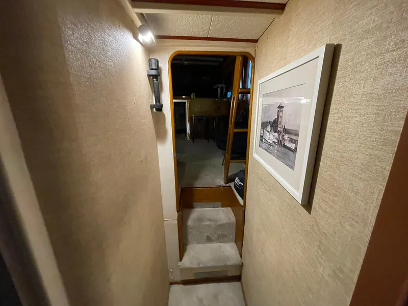 Slide: The Image of 1951 Chris-Craft Catalina interior hallway with framed photo and soft lighting. - 23