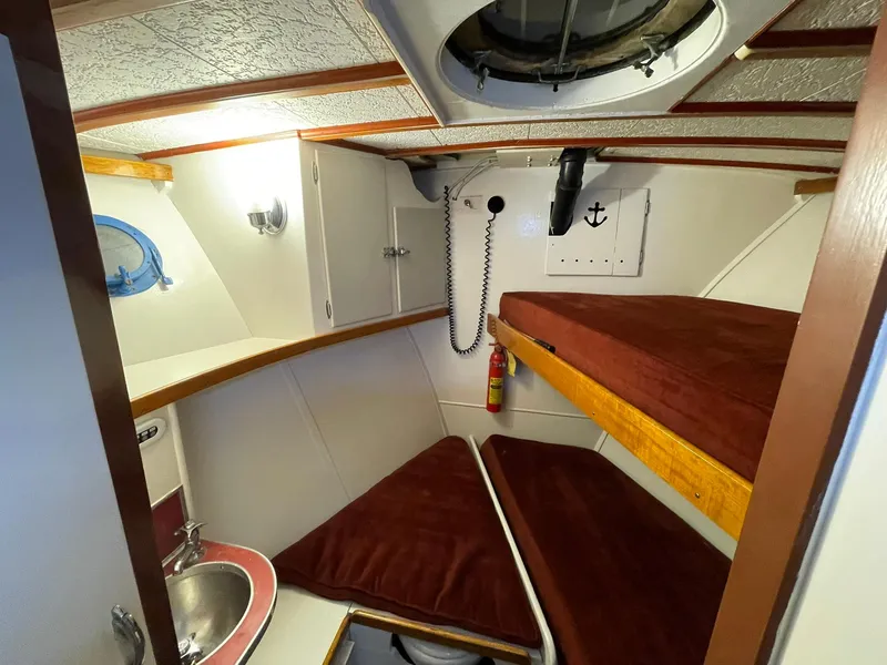 Slide: The Image of 1951 Chris-Craft Catalina cabin interior with bunk beds and sink. - 31