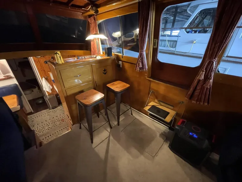 Slide: The Image of Interior of a 1951 Chris-Craft Catalina boat with wooden decor and bar stools. - 9