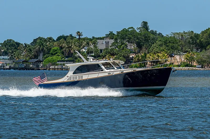 Slide: The Image of 2015 Hinckley Talaria 48 yacht cruising on a sunny day with American flag. - 1