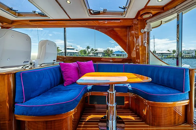 Slide: The Image of Luxurious interior of 2015 Hinckley Talaria 48 yacht with blue seating and wooden accents. - 12