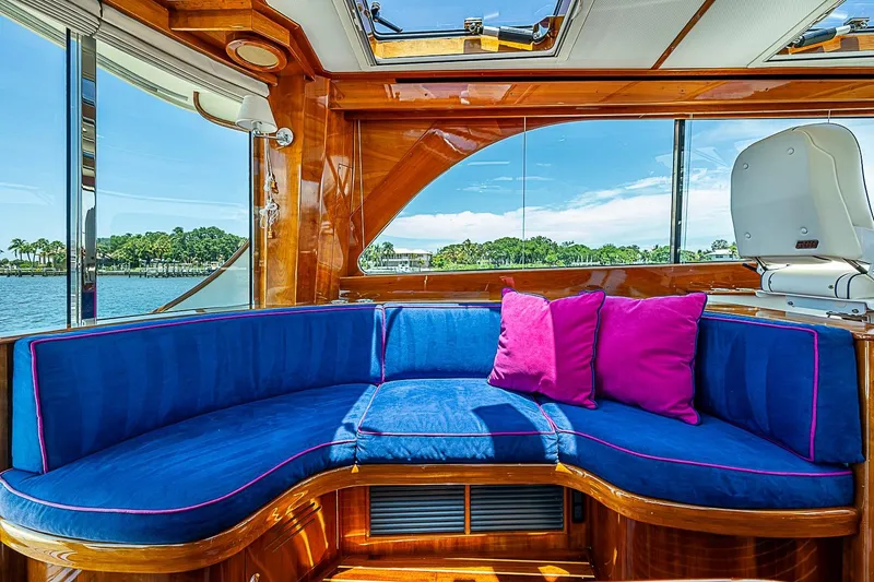 Slide: The Image of Luxurious interior of 2015 Hinckley Talaria 48 yacht with blue seating and pink cushions. - 13