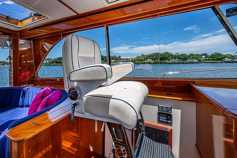 Slide: The Image of Luxurious interior of 2015 Hinckley Talaria 48 yacht with captain's chair and scenic view. - 14