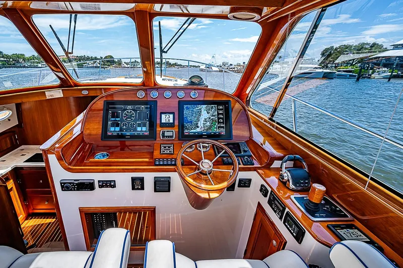 Slide: The Image of Luxurious 2015 Hinckley Talaria 48 yacht cockpit with advanced navigation systems and wooden finishes. - 16