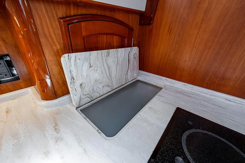 Slide: The Image of Hinckley Talaria 48 yacht kitchen with elegant wood and marble countertop, 2015 model. - 19