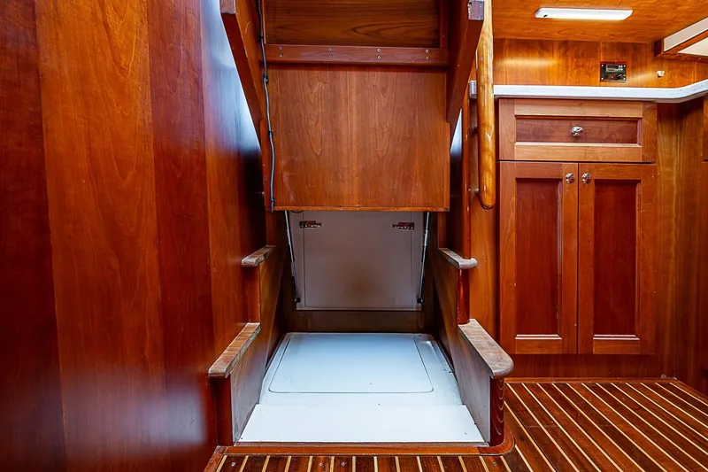 Slide: The Image of Interior of 2015 Hinckley Talaria 48 yacht, featuring elegant wooden cabinetry and flooring. - 21