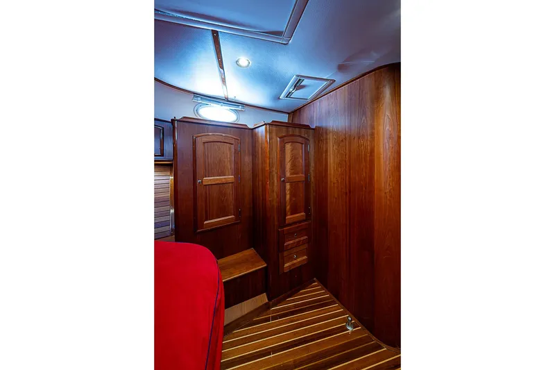 Slide: The Image of Luxurious wooden interior of 2015 Hinckley Talaria 48 yacht cabin with elegant cabinetry. - 23