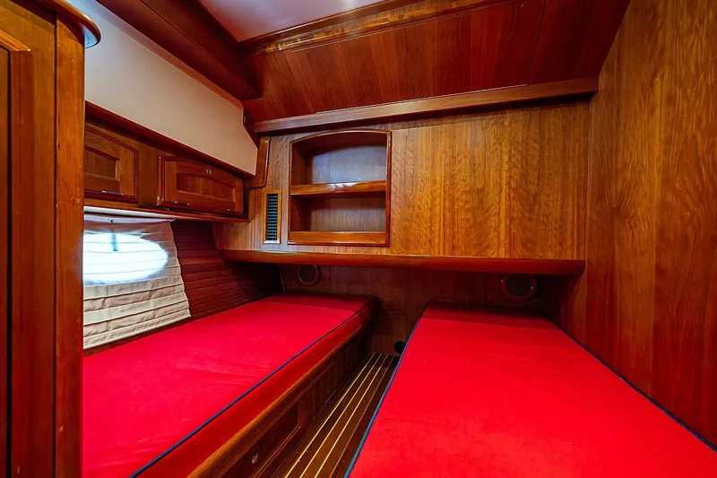 Slide: The Image of Luxurious wooden cabin interior of 2015 Hinckley Talaria 48 yacht with red bedding. - 24