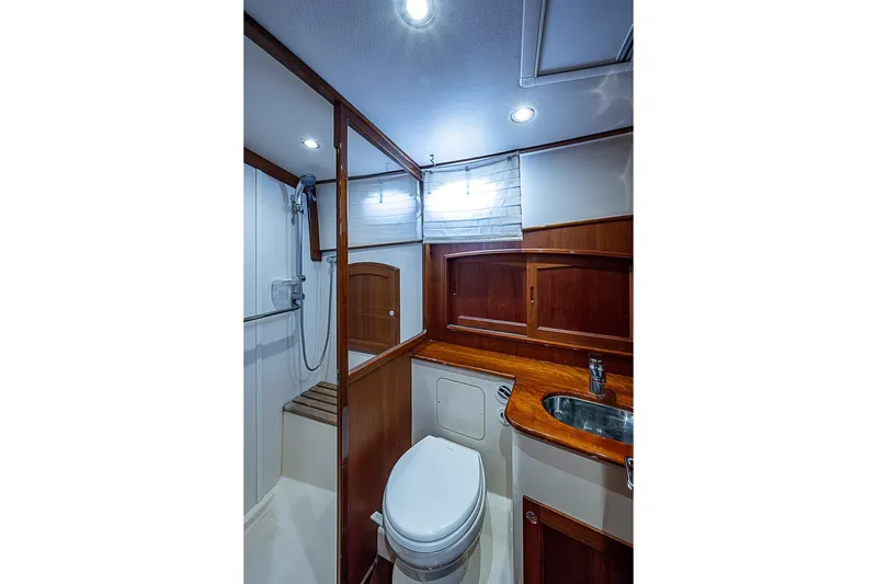 Slide: The Image of Luxurious 2015 Hinckley Talaria 48 yacht bathroom with wood accents and modern fixtures. - 27